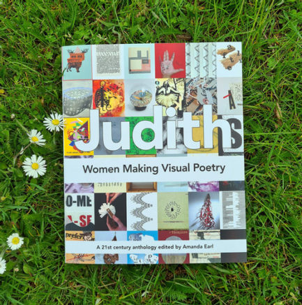A book titled Judith on a patch of grass.